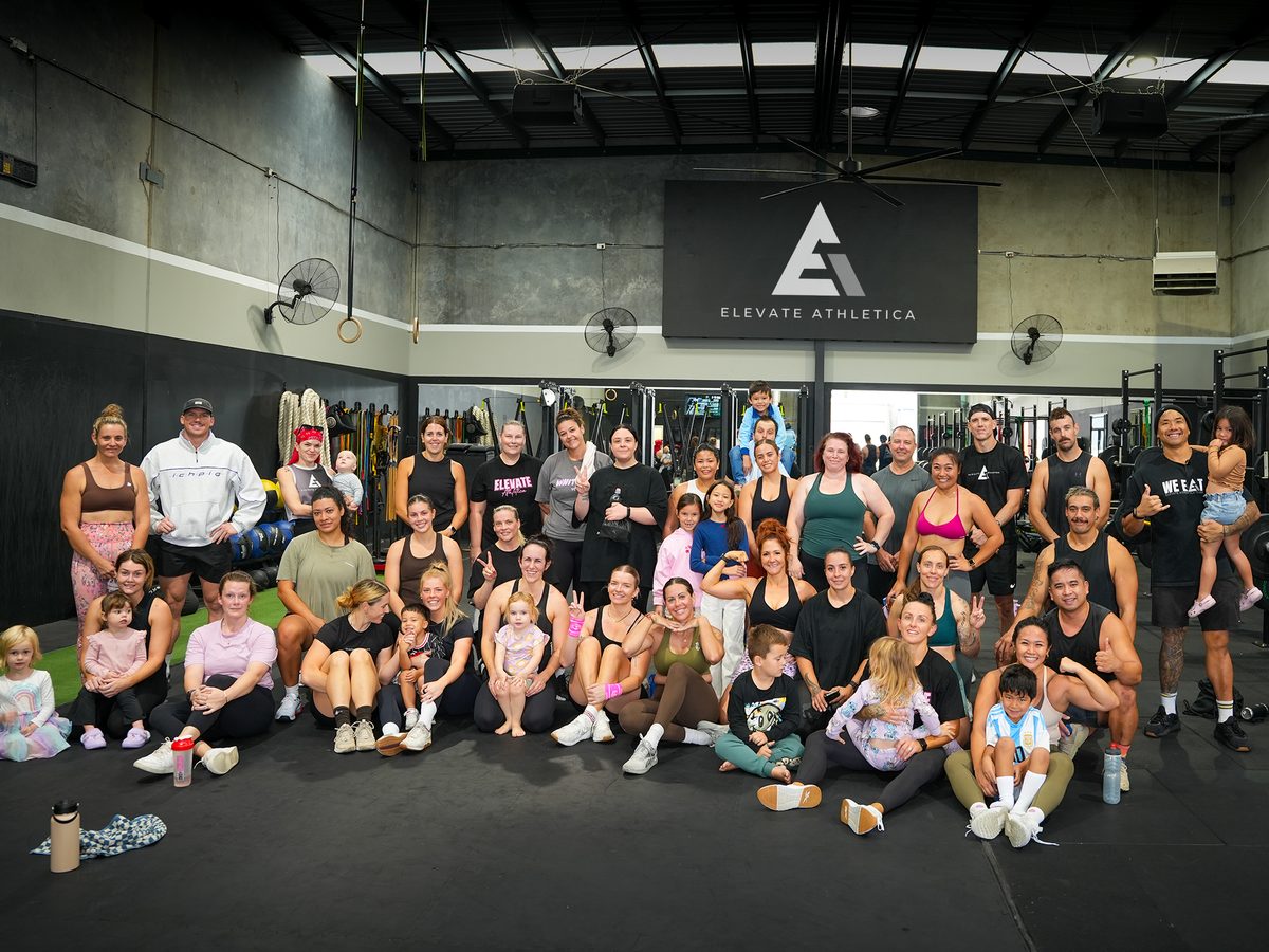 Elevate Athletica members and coaches together on the gym floor