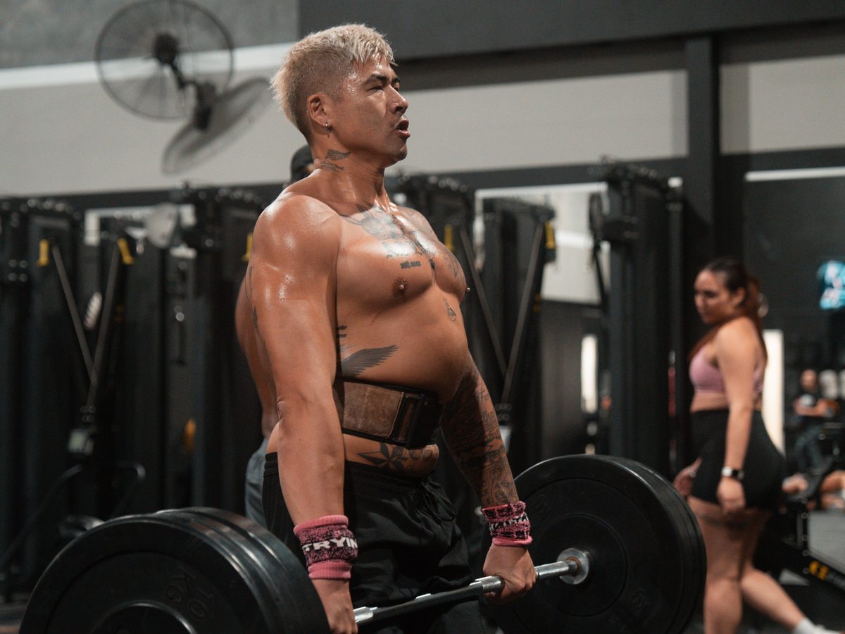Athlete lifting a heavy barbell in a functional strength training class